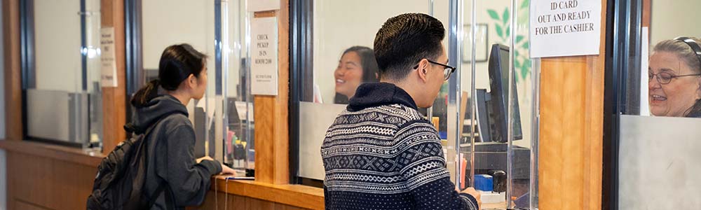 Students standing at cashier windows.
