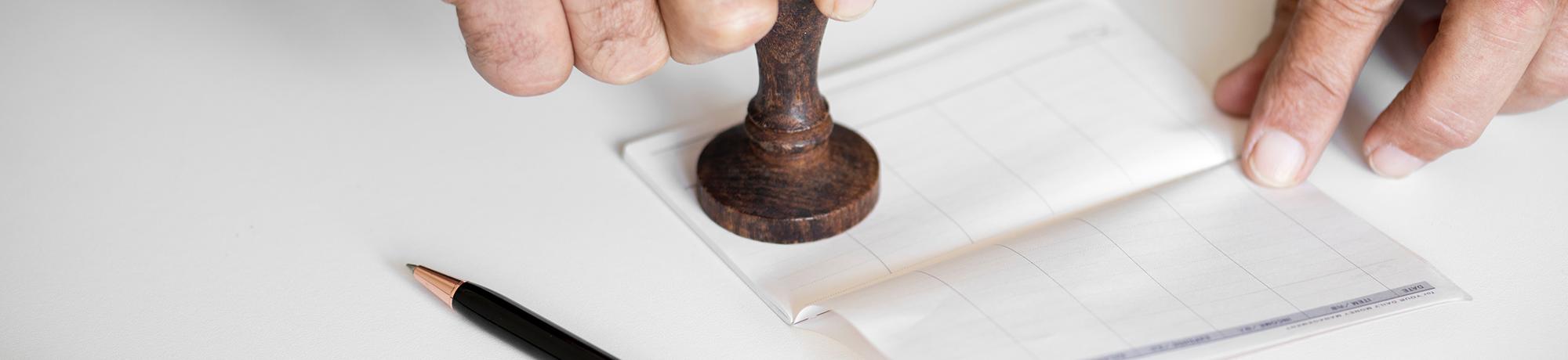 male hands stamping a checkbook